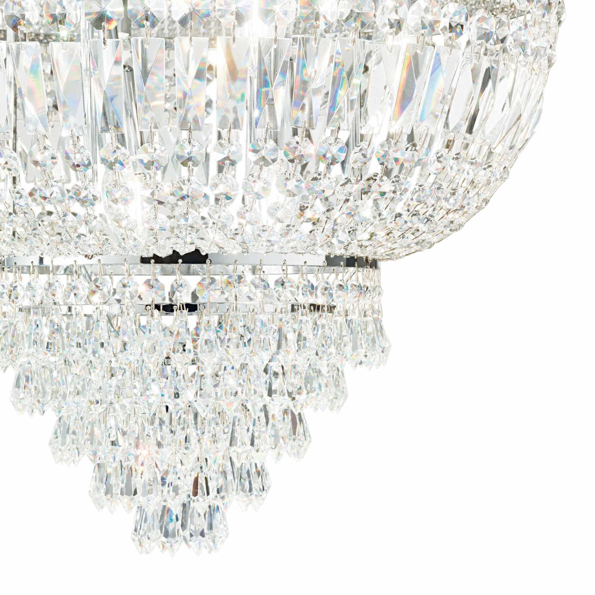 zoom of chrome and clear cut crystal chandelier on white background